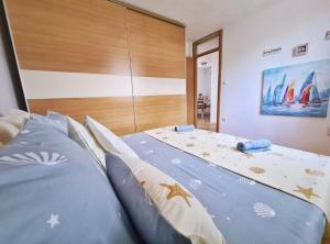 a bedroom with a large bed with blue pillows at Apartments for families with children Solin, Split - 21472 in Solin