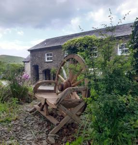 a wooden wheel sitting in front of a building at The Mews, Talley in Llandeilo