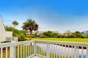 a balcony with a view of a golf course at Driftwood Villa - 240 in Edisto Island