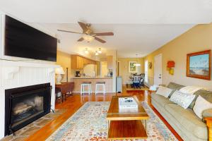 a living room with a couch and a fireplace at Driftwood Villa - 240 in Edisto Island