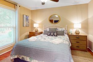a bedroom with a large bed and a mirror at Driftwood Villa - 240 in Edisto Island