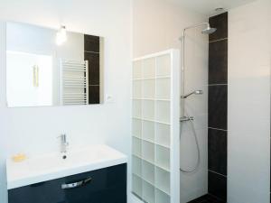 a white bathroom with a sink and a shower at Gîte familial près de Nancy avec grand jardin, spa, salle de jeux, et équipements pêche - FR-1-584-15 in Laneuveville-devant-Bayon +12 photos