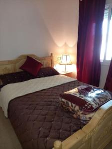 a bedroom with a large bed and a window at APPARTEMENT AL WAHDA in Taza