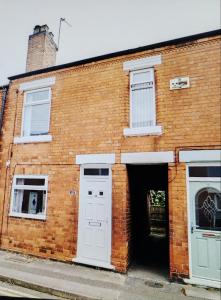 a brick building with a door and two windows at #Nottingham entire house, #Hucknall in Hucknall