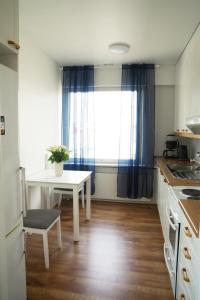 a small kitchen with a table and a window at 3-Room Central Railway station in Oulu