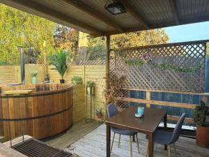 a patio with a table and a hot tub at Cabañas Vista Campana in Hijuelas
