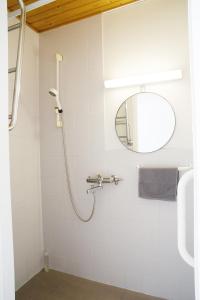 a bathroom with a shower and a mirror at 3-Room Central Railway station in Oulu