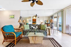 a living room with a couch and a table at Royal Kahana 1212 in Kahana
