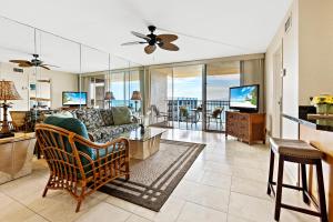 a living room with a couch and a tv at Royal Kahana 1212 in Kahana +26 photos