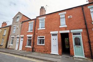a red brick building with white doors on a street at #Nottingham entire house, #Hucknall in Hucknall