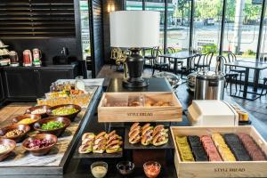 a buffet with different types of food on a table at HOTEL MYSTAYS Matsuyama in Matsuyama
