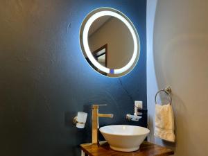a bathroom with a sink and a mirror on a wall at Hotel La Bikina in Tequila