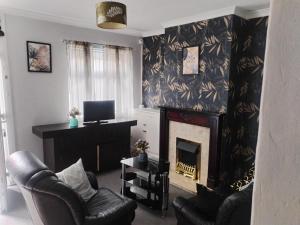 a living room with a fireplace and a television at #Nottingham entire house, #Hucknall in Hucknall