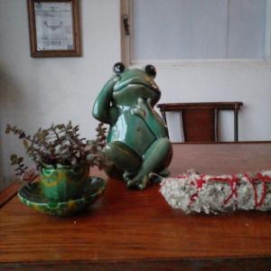 a statue of a frog sitting on a table at Vive Alegria Hostel in Puerto Vallarta