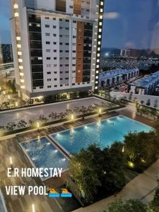 an overhead view of a building with a swimming pool at E. R Homestay 3R2B nearby KLIA in Sepang