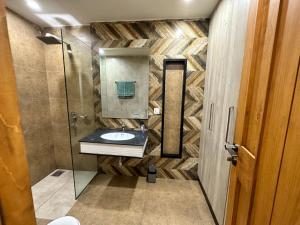 a bathroom with a sink and a shower at 2 Bed Apartment near Gulberg in Lahore