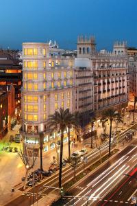 a large building on a city street at night at Wilson Boutique Hotel in Barcelona