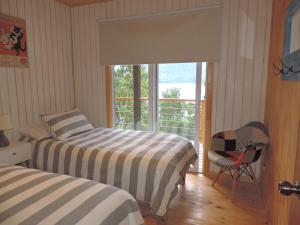 Ένα ή περισσότερα κρεβάτια σε δωμάτιο στο Cabañas Loft Alto Arrayan Cochamó