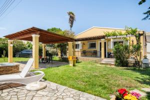 a house with a backyard with a gazebo at St. George Villa in Agios Georgios