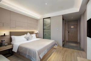 Postel nebo postele na pokoji v ubytování Morning Hotel, Wuhan Jinyin Lake Garden Expo Garden Yuya Yinhu City