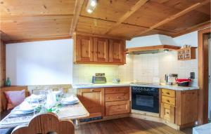 a kitchen with wooden cabinets and a table in a room at Nice Apartment In Pfronten With Sauna, Wifi And 1 Bedrooms in Pfronten