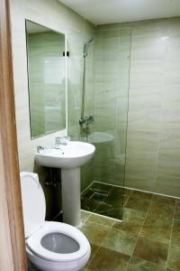 a bathroom with a toilet and a sink and a shower at J Hotel in Ulaanbaatar