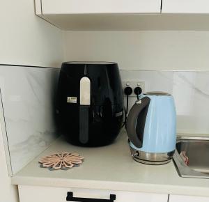 a kitchen counter with a coffee maker and a toaster at Lux Studio in Dunedin Central in Dunedin