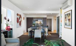 a dining room and kitchen with a table and chairs at 306 The Frontage in Victor Harbor