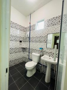 a bathroom with a toilet and a sink at Semrock Hotel 仙乐酒店 in Semporna +31 photos