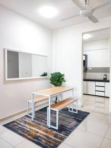 a table and bench in a room with a kitchen at Meru View in Ipoh