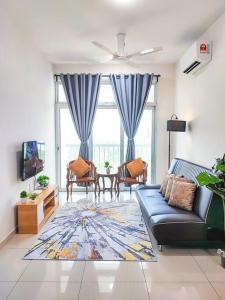 a living room with a couch and a tv at Meru View in Ipoh
