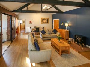 a living room with a couch and a table at The Bothy in Ivegill