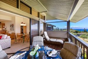 a living room with a balcony with a view of the ocean at Kapalua Ridge Villa 2622 in Kahana