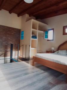 a bedroom with a bed and a balcony at Chacras casa Armonia in Chacras de Coria