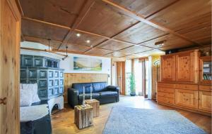 a living room with a leather couch and wooden ceilings at Nice Apartment In Pfronten With Sauna, Wifi And 1 Bedrooms in Pfronten