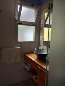 a bathroom with a bowl sink and a window at Chacras casa Armonia in Chacras de Coria