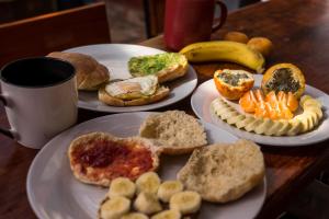 a table topped with plates of food and a cup of coffee at Aldos Guest House in Huaraz