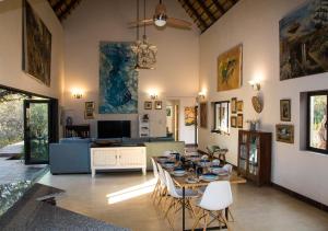 a living room with a table and a couch at Exbury Wild in Hoedspruit