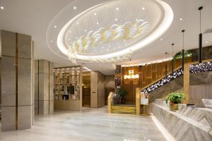 a lobby with a large chandelier in a building at Morning Hotel, Changsha Langli in Changsha