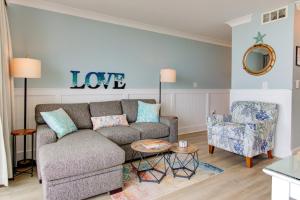 een woonkamer met een bank en een stoel bij 0304 Bountiful Bliss by Atlantic Towers in Carolina Beach