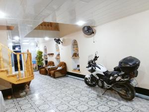a motorcycle parked in a room with a living room at Minorai Xurd in Bukhara