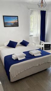 a bedroom with a large bed with a blue blanket at Lizo Hotel in Kalkan
