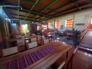a dining room with a wooden table and chairs at mini-hogar en santa teresa in Santa Teresa