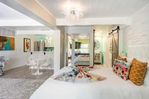 a bedroom with a white bed and a dining room at Stylish Retro Luxury Close to SF and Wine Country Regions in San Rafael