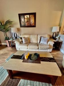 a living room with a couch and a coffee table at Dream Vacation Lovely Condo minutes from Beach King bed Heated pool Gym in Clearwater