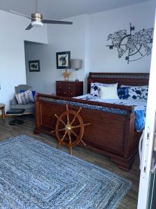 a bedroom with a large bed with a wooden wheel at Earls Cove Orca View in Egmont