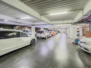 a parking garage with cars parked in it at Sang Surya GuestHouse Syariah Near RS Hasan Sadikin Mitra RedDoorz in Bandung