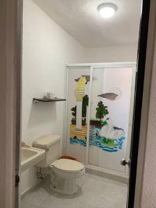 a bathroom with a toilet and a sink at Casa de Cielo y Mar en Cancún in Cancún