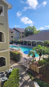 an image of a swimming pool in a apartment complex at Dream Vacation Lovely Condo minutes from Beach King bed Heated pool Gym in Clearwater