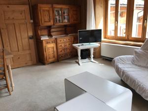 a living room with a couch and a tv and a table at Apartment Walter in Vals